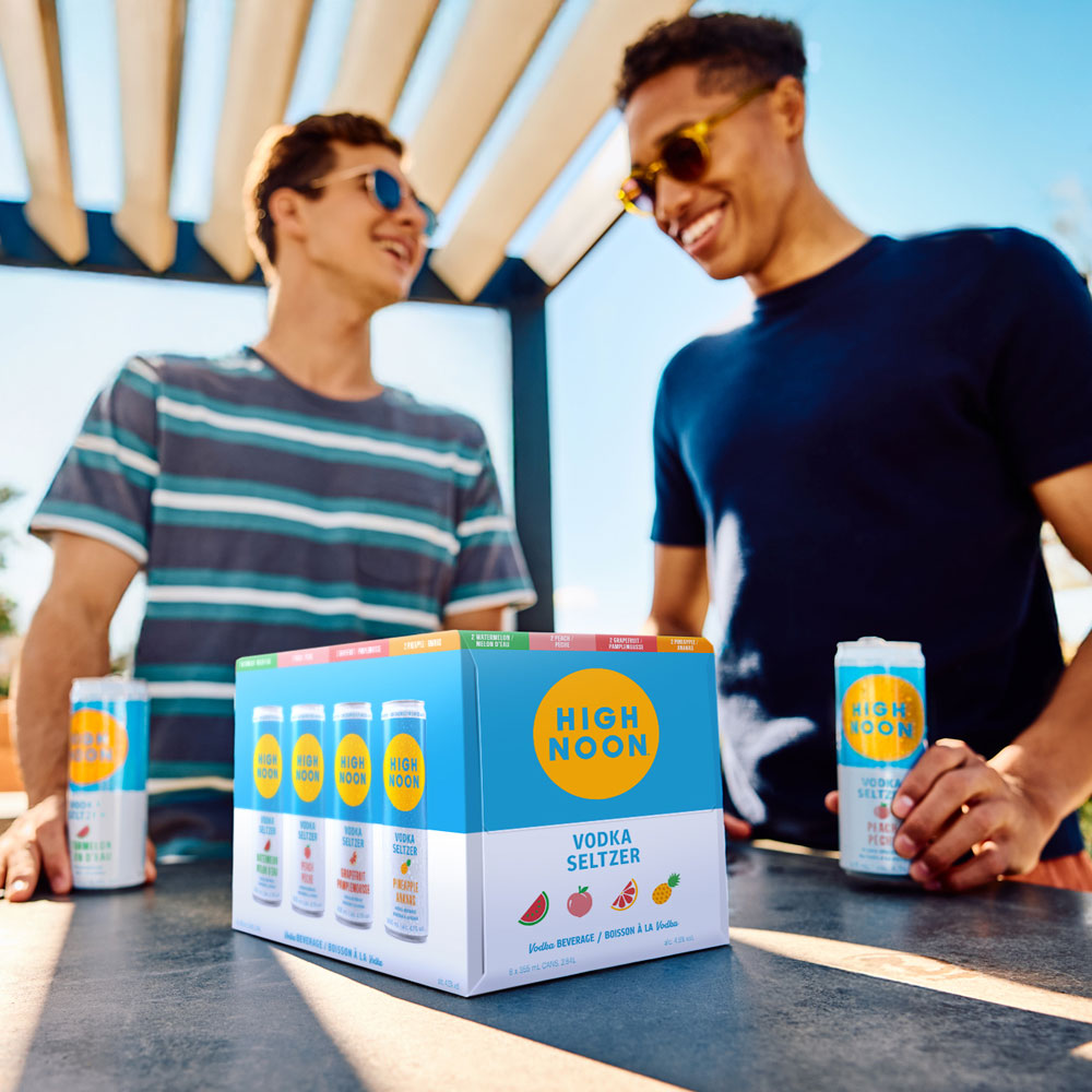 Friends sharing high noon vodka seltzer.
